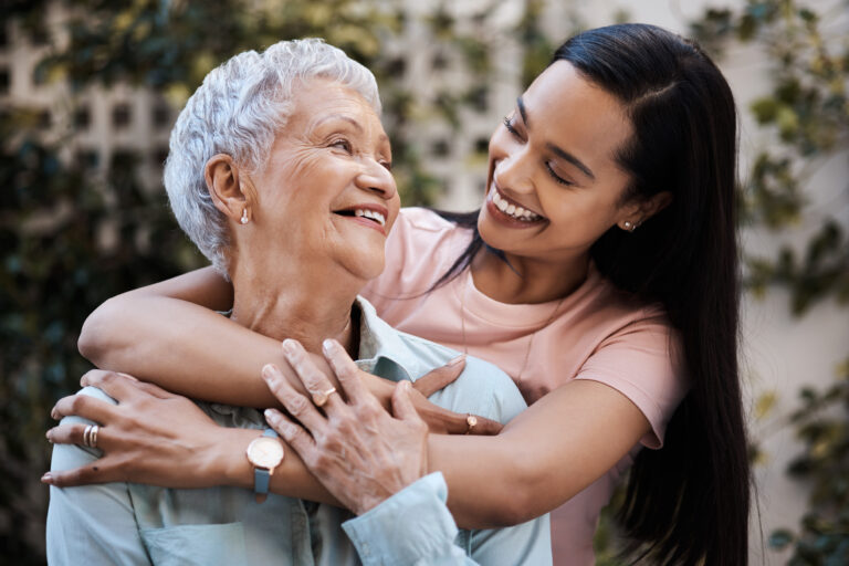 Happy, hug and loving of a mother and woman in a garden on mothers day with care and gratitude together. Smile, family and an adult daughter hugging a senior mom in a backyard or park for happiness.